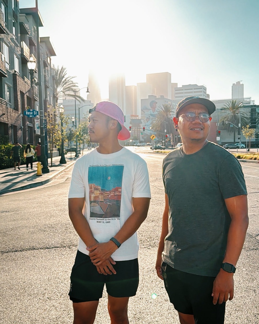 Oak and Bright standing in a sunlit downtown Los Angeles street after a morning run
